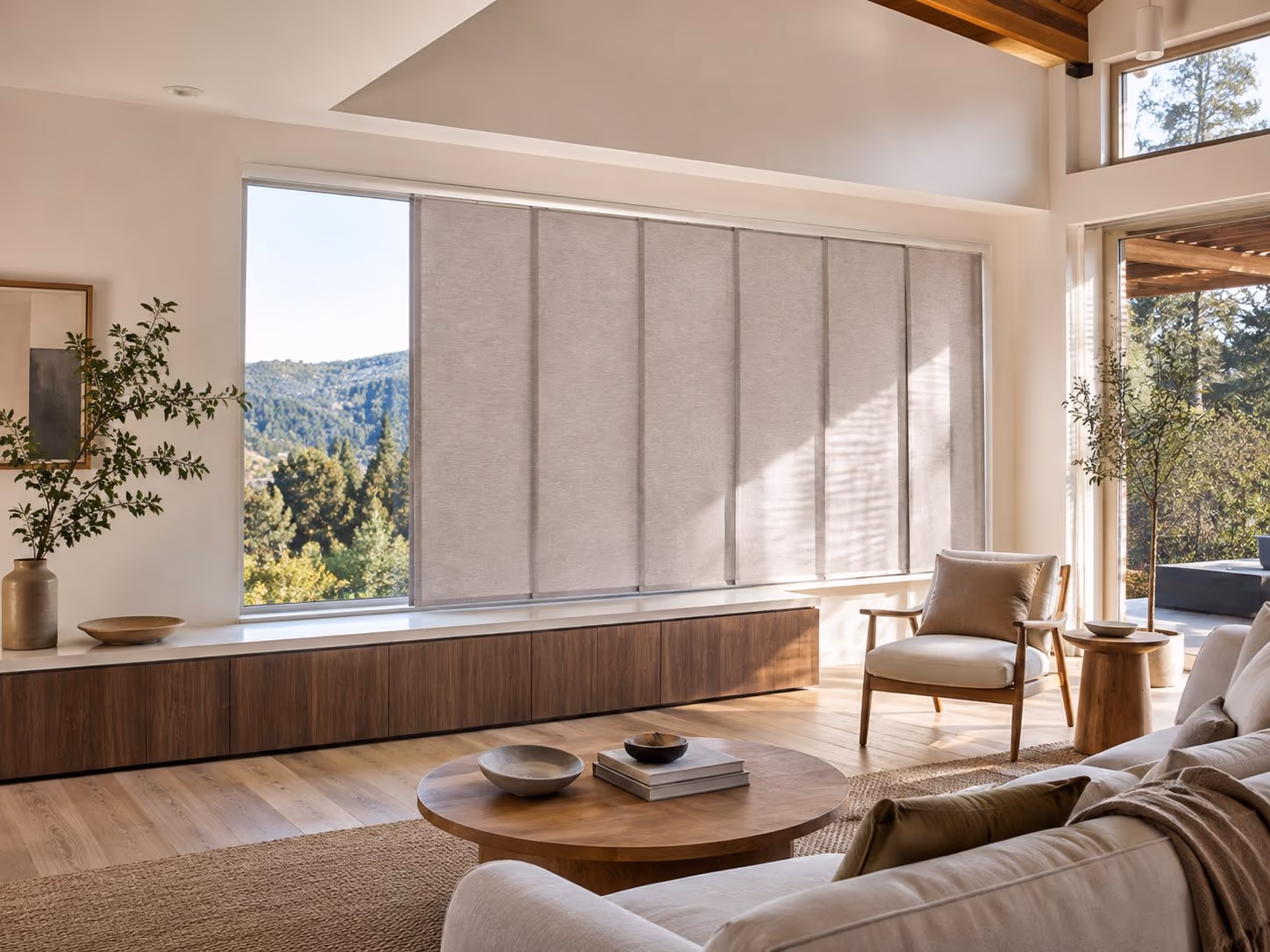 A gliding panel-track system across a wide opening in a bright Sonoma County home — Skyline Gliding Window Panels installed by Discount Best Blinds of Santa Rosa, CA.