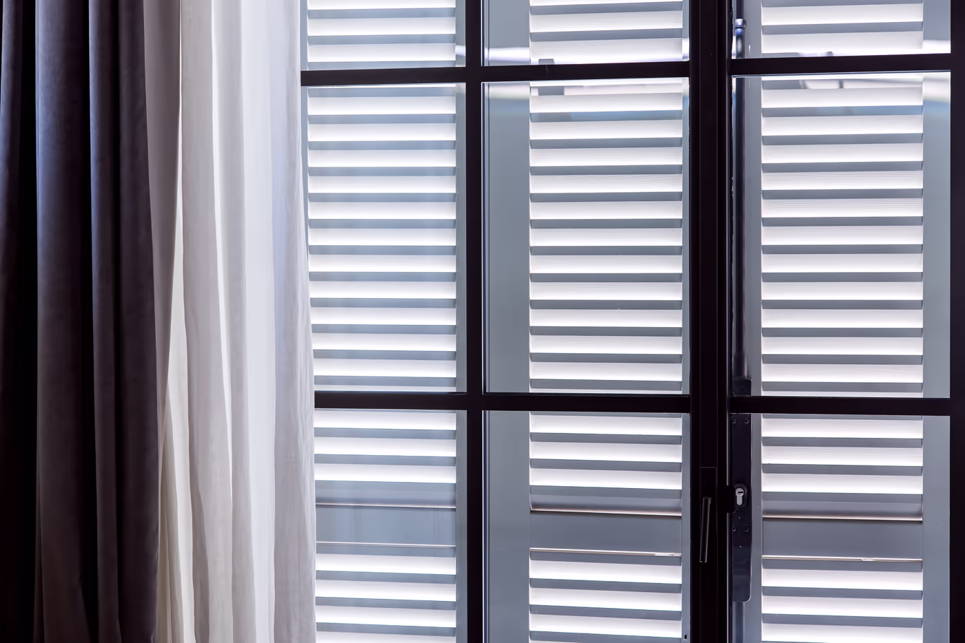 Custom shutters layered with drapery in a Sonoma County home
