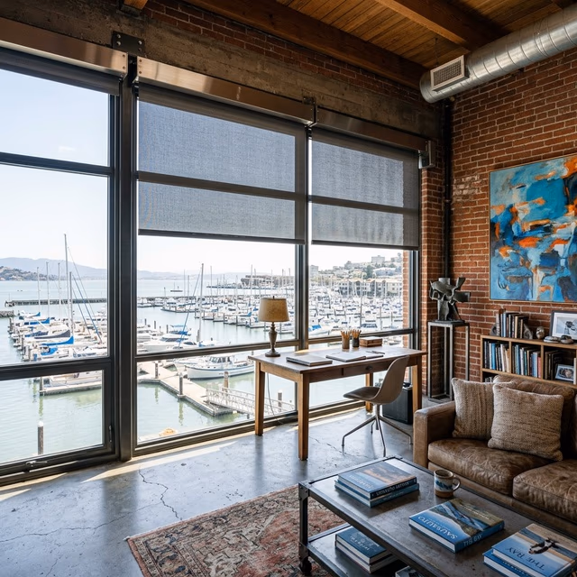 Discount Best Blinds and Shutters marine-grade motorized solar shades with salt-air resistant hardware filtering Richardson Bay light in a Marinship waterfront studio, Sausalito CA 94965