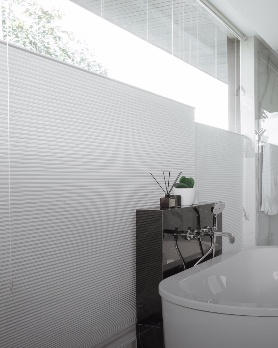 Hunter Douglas cellular shades for energy-efficient heat retention in luxury marble bathroom