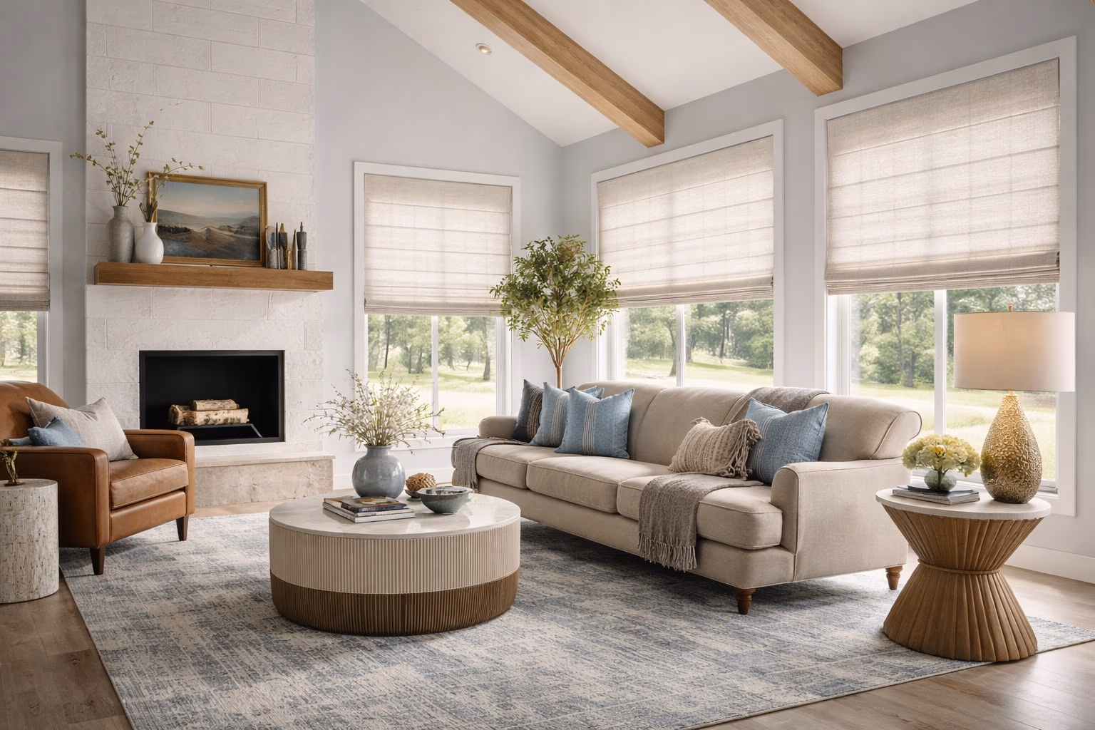 Hunter Douglas Roman Shades on multiple windows in a modern farmhouse living room with vaulted beam ceiling white brick fireplace and blue pillows, installed by Discount Best Blinds and Shutters